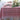 A red and white geometric patterned tablecloth on a dining table set for a meal with plates and a centerpiece.