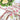 Decorative tablecloth with floral and vine design on a table.